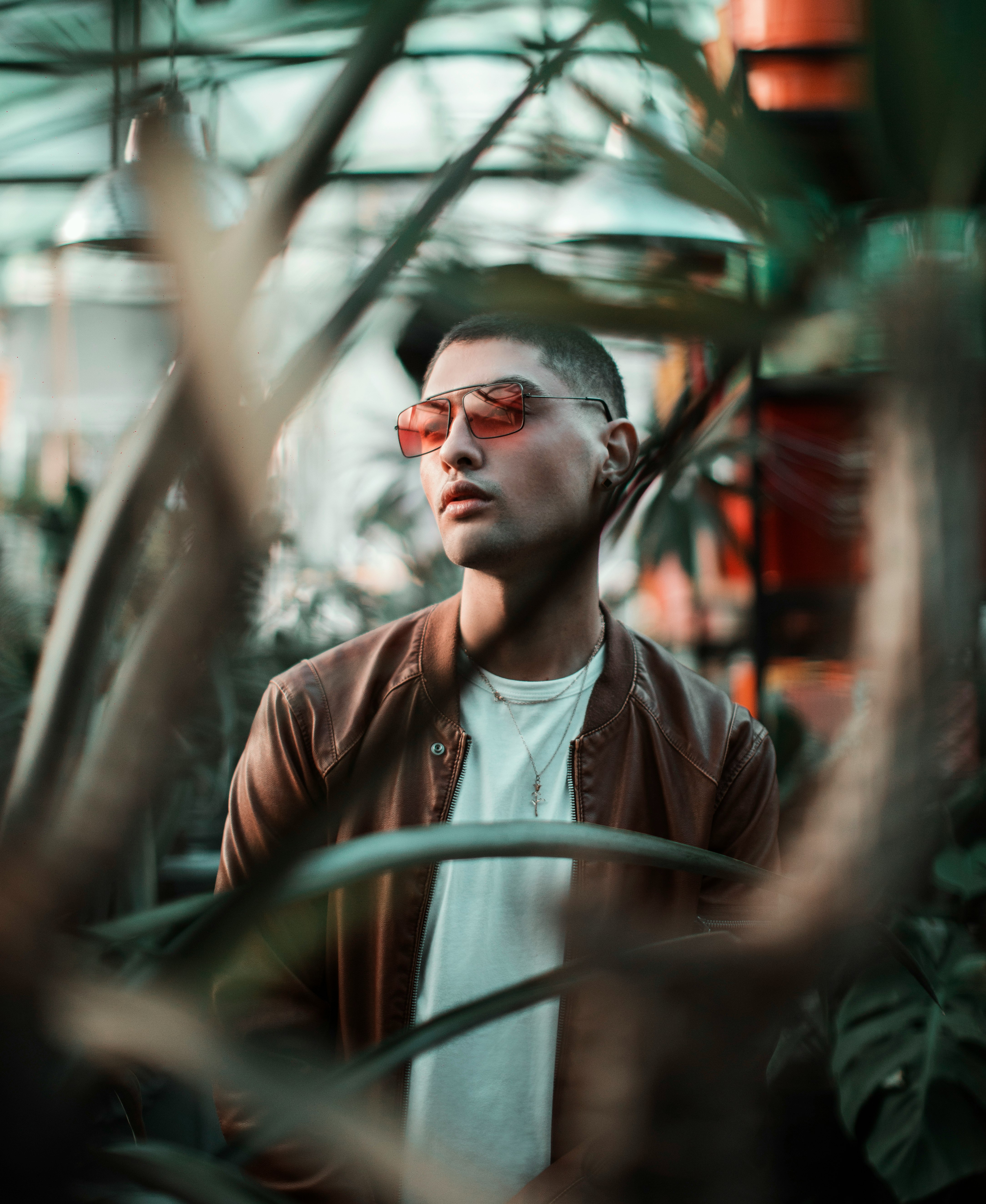 man in brown leather jacket wearing sunglasses